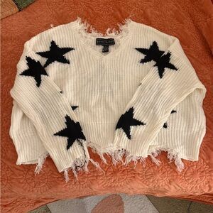 Distressed Oversized White Sweater with Black Stars